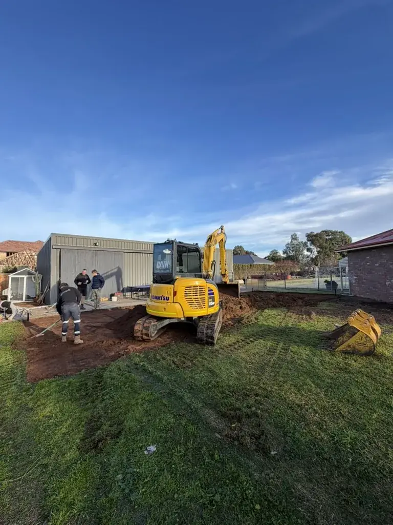 CEG excavator working alongside a builder's crew