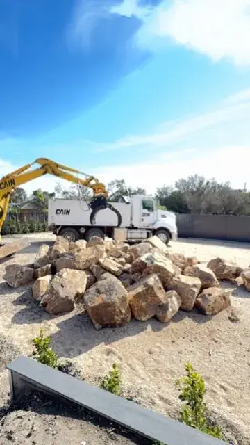 Hydraulic grab placing rock
