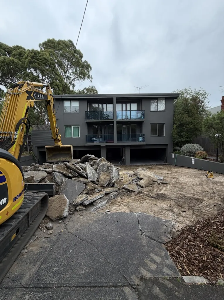 Broken-out concrete driveway stockpiled by the CEG excavator